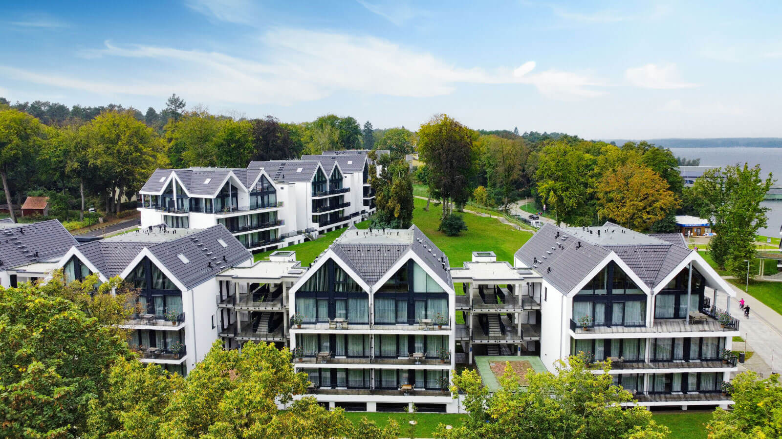 A group of buildings surrounded by trees and grass, representing outdoor real estate investment mana