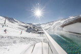 Pool amidst snow at a ski resort, perfect for winter sports and relaxation.