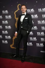 A man wearing a tuxedo for a picture at 12.18 Investment Management GmbH premiere event.