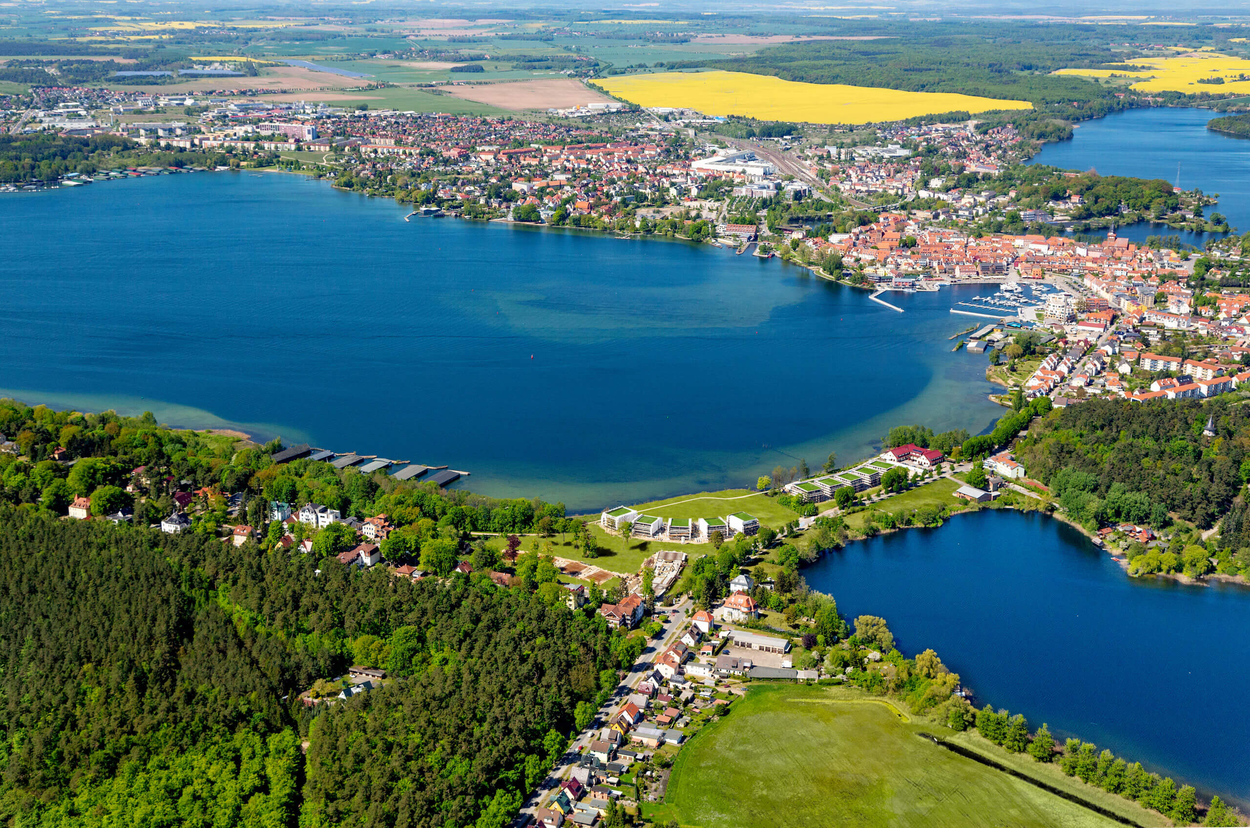 An aerial view of a city and a lake
