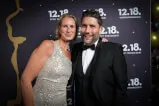 A man and woman posing for a picture. The image is associated with 12. 18. Investment Management GmbH on their website https://12-18.com. The individuals are wearing formal attire and are smiling, conveying a sense of professionalism and elegance.