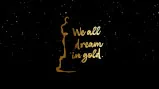 Goldener Text 'We all... dream in gold' auf schwarzem Hintergrund mit Sternen