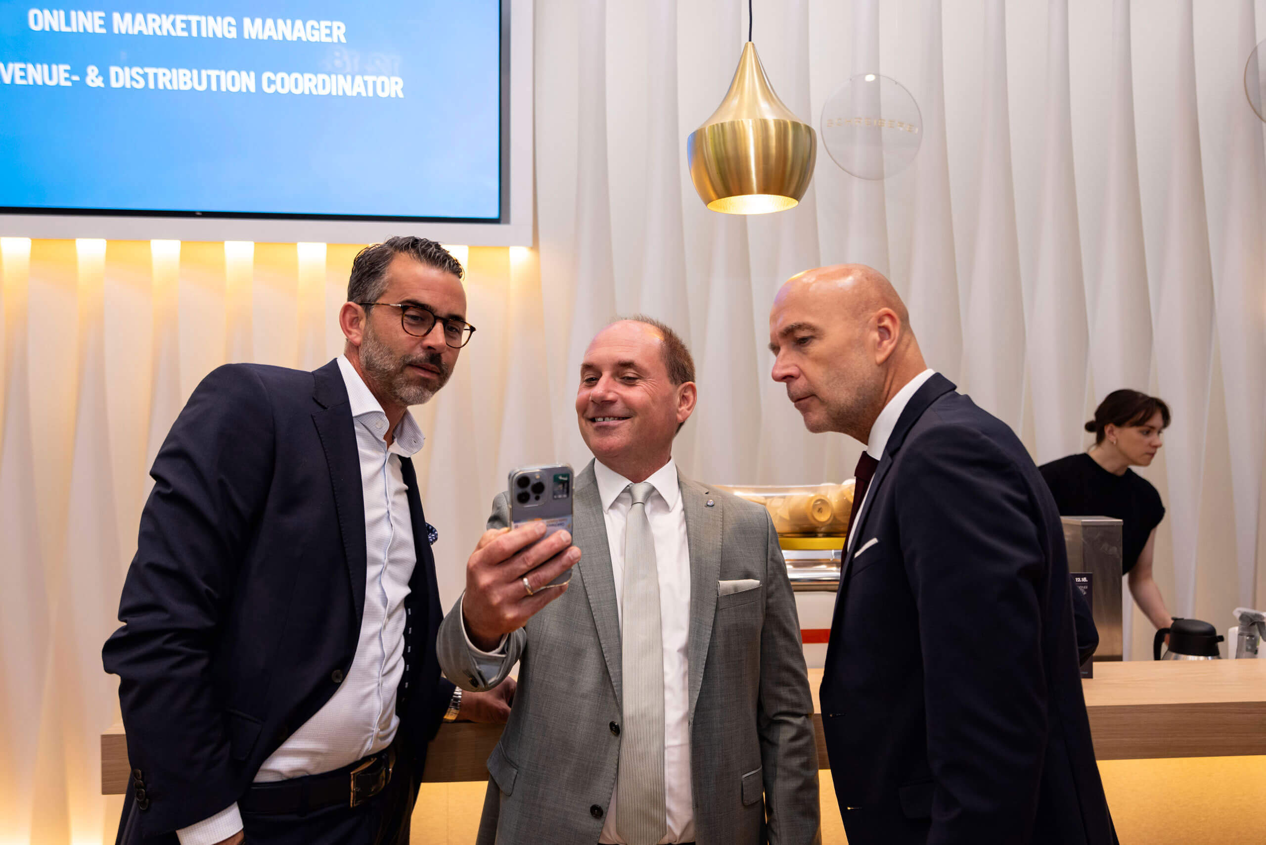 Eine Gruppe Männer in Anzügen macht ein Selfie bei 12. 18. Investment Management GmbH