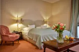 A cozy room with a bed and a vase of flowers in a 12. 18. Investment Management GmbH property