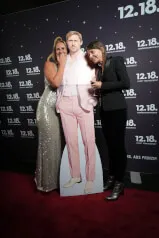 Two women posing next to a cardboard cutout of a man at 12. 18. Investment Management GmbH's website.